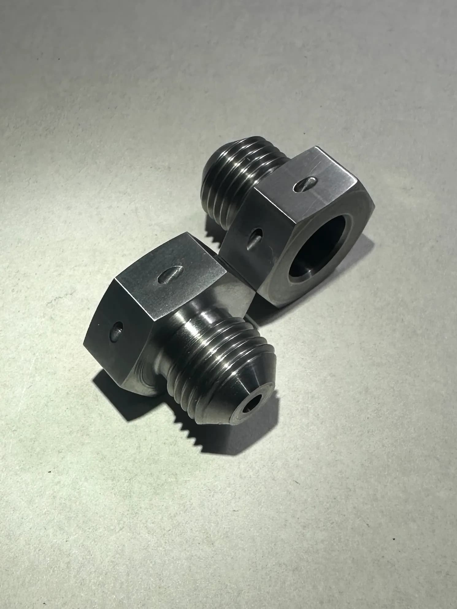 Precision CNC-turned aerospace hydraulic union fitting representative of components produced daily